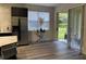 Bright dining area with stainless steel refrigerator, glass table, and sliding glass doors to the patio at 9238 Kensington Row Ct, Orlando, FL 32827