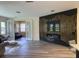 Modern living room featuring hardwood floors, a decorative black accent wall and modern fireplace at 9238 Kensington Row Ct, Orlando, FL 32827