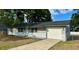 Charming single-story home featuring a brick facade, a well-manicured lawn, and an attached garage at 1801 James St, South Daytona, FL 32119