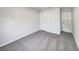 Bright, carpeted bedroom with white walls and doors at 1078 Osprey Cove Cir, Groveland, FL 34736