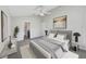 Well-lit bedroom featuring a striped bed frame and ceiling fan, creating a cozy and inviting atmosphere at 1078 Osprey Cove Cir, Groveland, FL 34736