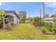 Large backyard provides a tranquil retreat, enhanced by lush greenery and plenty of space for outdoor activities at 1521 Oxford Rd, Maitland, FL 32751