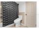 Bathroom featuring a toilet, shower/tub combo with a black and white patterned shower curtain at 1521 Oxford Rd, Maitland, FL 32751