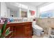 Bathroom with a wood vanity, granite countertop, and tiled walls at 1521 Oxford Rd, Maitland, FL 32751