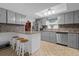 Modern kitchen with a breakfast bar, stainless steel appliances, and stylish gray cabinetry at 1521 Oxford Rd, Maitland, FL 32751