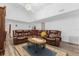 Spacious living room with vaulted ceiling, comfy leather seating, and stylish decor on wood floors at 1521 Oxford Rd, Maitland, FL 32751