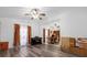 Large living room with ceiling fans, wood floors, and plenty of natural light through large windows at 1521 Oxford Rd, Maitland, FL 32751