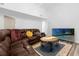 Comfortable living area with a large brown couch and a flat screen TV against white walls at 1521 Oxford Rd, Maitland, FL 32751