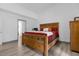 Spacious main bedroom with wood-look floors, a wooden bed frame, and en-suite bathroom access at 1521 Oxford Rd, Maitland, FL 32751