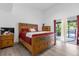 Comfortable main bedroom with a wooden bed frame, matching furniture, and sliding door access to the lanai at 1521 Oxford Rd, Maitland, FL 32751