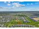 An aerial view showcases the desirable neighborhood and prime location of the home, complete with lush greenery and blue skies at 1697 Kona Ln, Davenport, FL 33897