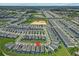 An aerial view showcases the desirable neighborhood and prime location of the home, complete with many screened-in pools at 1697 Kona Ln, Davenport, FL 33897