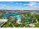 Stunning aerial view of the community pool, lazy river and blue rooftops of the resort area at 1697 Kona Ln, Davenport, FL 33897