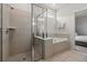 Modern bathroom featuring a glass-enclosed shower and a soaking tub at 1697 Kona Ln, Davenport, FL 33897