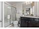 Bathroom featuring a glass-enclosed shower and granite countertops at 1697 Kona Ln, Davenport, FL 33897