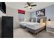 Bright bedroom featuring two twin beds with decorative Mickey Mouse pillows and a ceiling fan at 1697 Kona Ln, Davenport, FL 33897