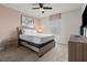 Well lit bedroom featuring a ceiling fan, a large bed with nightstands and a dresser at 1697 Kona Ln, Davenport, FL 33897