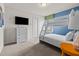 bedroom with a bunk bed, blue walls with custom artwork and a flat screen TV at 1697 Kona Ln, Davenport, FL 33897