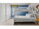 bedroom with a bunk bed, blue walls with custom artwork and a bright window at 1697 Kona Ln, Davenport, FL 33897