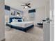 Bright bedroom featuring a blue accent wall, plush carpet, ceiling fan, and comfortable furnishings at 1697 Kona Ln, Davenport, FL 33897