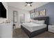 Comfortable bedroom featuring a king-size bed, neutral colors, and ensuite bathroom at 1697 Kona Ln, Davenport, FL 33897