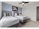 Bright bedroom featuring two twin beds with decorative Mickey Mouse pillows and a ceiling fan at 1697 Kona Ln, Davenport, FL 33897