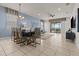 Stylish dining room featuring modern lighting, seating for six, tile floors, and an open-concept design at 1697 Kona Ln, Davenport, FL 33897