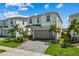 Well-maintained two-story home featuring a two-car garage, manicured lawn, and a brick-paved driveway at 1697 Kona Ln, Davenport, FL 33897