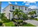 Well-manicured lawn and lush landscaping surrounds this two-story home with paved driveway and a two-car garage at 1697 Kona Ln, Davenport, FL 33897