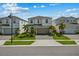 Charming two-story home featuring a well-maintained lawn and a two-car garage with a paved driveway at 1697 Kona Ln, Davenport, FL 33897