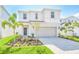 Charming two-story home featuring a beautifully landscaped front yard and a two-car garage at 1697 Kona Ln, Davenport, FL 33897