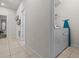 Functional laundry area located along the hallway with included appliances for convenience at 1697 Kona Ln, Davenport, FL 33897