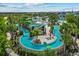The community lazy river features a waterslide, shaded seating, and beautifully landscaped walkways at 1697 Kona Ln, Davenport, FL 33897
