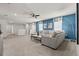 Spacious carpeted living room with comfortable seating and a blue accent wall at 1697 Kona Ln, Davenport, FL 33897