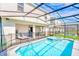 The backyard has a screened-in pool, spa, lounge area, and outdoor dining space at 1697 Kona Ln, Davenport, FL 33897