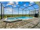 Screened-in pool with an attached jacuzzi provides a relaxing outdoor retreat and views at 1697 Kona Ln, Davenport, FL 33897