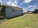 Backyard view of home showcasing yard space, and block style exterior of home at 1951 S Crystal Lake Dr, Orlando, FL 32806