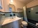 Retro bathroom featuring blue tile, chrome fixtures, and shower at 1951 S Crystal Lake Dr, Orlando, FL 32806