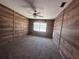 Bedroom with carpet floors, panel walls, and a bright window at 1951 S Crystal Lake Dr, Orlando, FL 32806