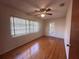 Bedroom featuring hardwood floors, bright window, and a ceiling fan at 1951 S Crystal Lake Dr, Orlando, FL 32806