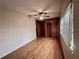 Bedroom with hardwood floors, white brick wall, closet, wood panel wall, and bright window at 1951 S Crystal Lake Dr, Orlando, FL 32806