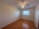 Cozy bedroom with hardwood floors, ceiling fan, and a window providing natural light at 1951 S Crystal Lake Dr, Orlando, FL 32806