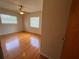 Bright bedroom with hardwood floors, ceiling fan, and natural light from two windows at 1951 S Crystal Lake Dr, Orlando, FL 32806