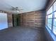 Bedroom with carpet floors, panel walls, and a bright window at 1951 S Crystal Lake Dr, Orlando, FL 32806
