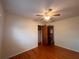 Bedroom featuring hardwood floors, ceiling fan, and a closet at 1951 S Crystal Lake Dr, Orlando, FL 32806