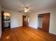 Bright bedroom featuring hardwood floors, ceiling fan, and closet at 1951 S Crystal Lake Dr, Orlando, FL 32806