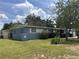 Exterior showcasing blue painted brick, manicured lawn, and established shrubbery at 1951 S Crystal Lake Dr, Orlando, FL 32806