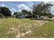 Exterior view of ranch style home with landscaped yard and tree in the front at 1951 S Crystal Lake Dr, Orlando, FL 32806