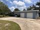 Exterior view of home featuring a three-car garage, manicured landscaping, and a concrete driveway at 1951 S Crystal Lake Dr, Orlando, FL 32806