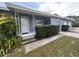 Inviting front entrance with decorative support posts and manicured greenery at 1951 S Crystal Lake Dr, Orlando, FL 32806